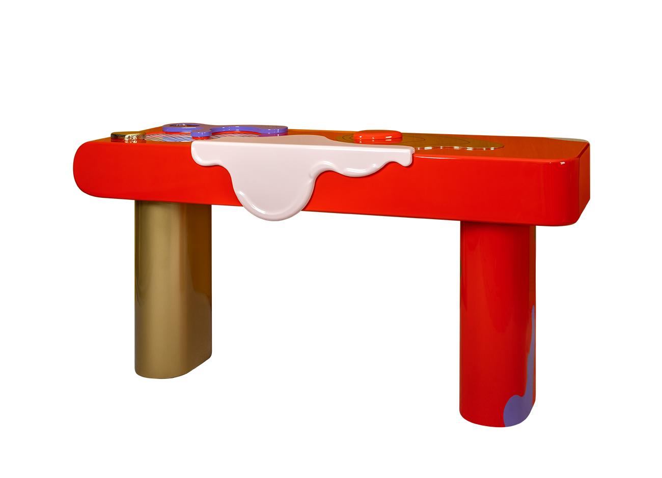 Right view of the la vie console featuring a hand-painted wooden top with simple abstract forms in bold colors, adorned with hammered and polished brass and glass details, supported by polished brass and lacquered wood feet.