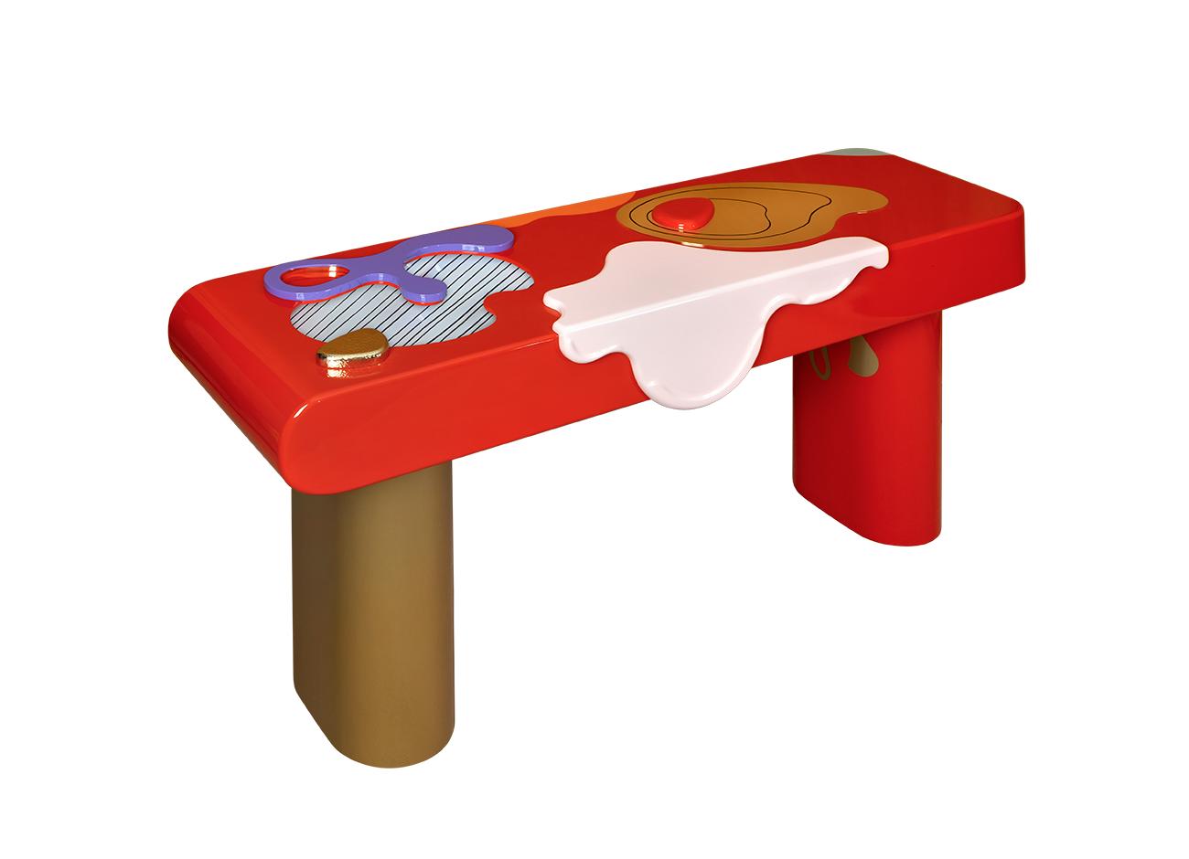 Top view of the la vie console showing its hand-painted wooden top with simple abstract forms in bold colors, adorned with hammered and polished brass and glass details, with drawers opening and closing, supported by polished brass and lacquered wood feet.