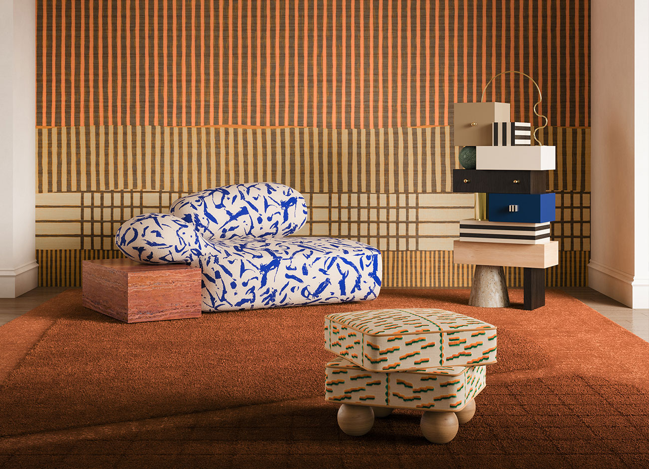 Viv id chaise longue Living room set featuring the viv id chaise longue upholstered in ichi-go ichi-e 001 fabric by dedar milano, paired with a travertino rosso cube. The madonna stool, upholstered in tiger beat 004 by dedar milano, stands on four oak sphere legs. Beside it, the sketch chest of drawers showcases ultramarine blue drawers, topped with a verde guatemala marble sphere and supported by a travertine base.