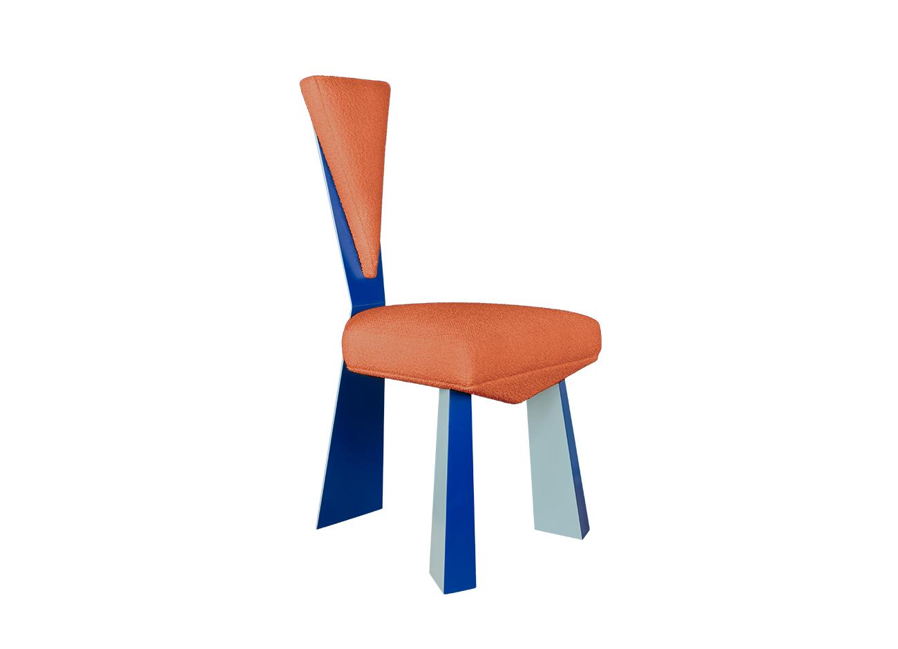 Kju bist dining chair by malabar photographed at a 45-degree front angle against a white background, emphasizing its cubist-inspired angular geometry, planar silhouette, blue lacquered legs, and bouclé orange fabric upholstery.