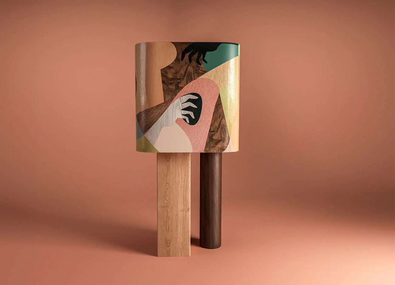 In Maj In Cabinet featuring a Cubism-inspired marquetry design made from white bleached oak, American walnut, and black-stained ashwood sheets. Supported by one cylindrical walnut leg and one rectangular oak leg. The interior is crafted from oak with a high-gloss colored translucent varnish.