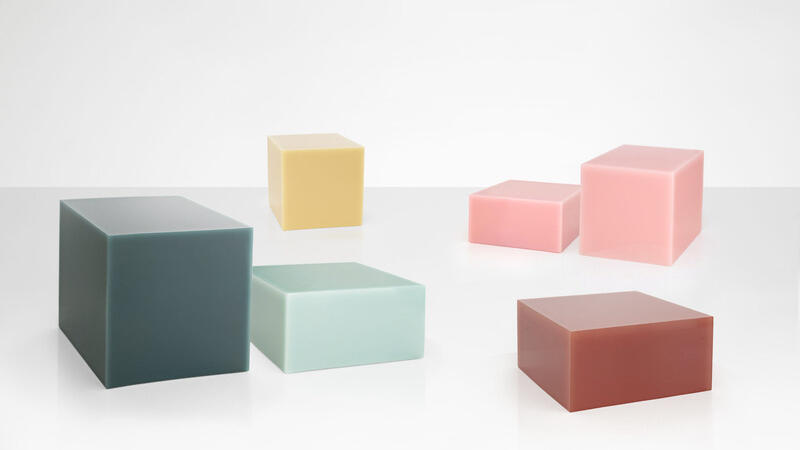 A polished, translucent resin cube in a vibrant hue, showcasing Sabine Marcelis's exploration of light and color. Originally designed as a sculptural side table, this piece has become an icon of collectible design and is part of the Museum of Modern Art's collection in New York.