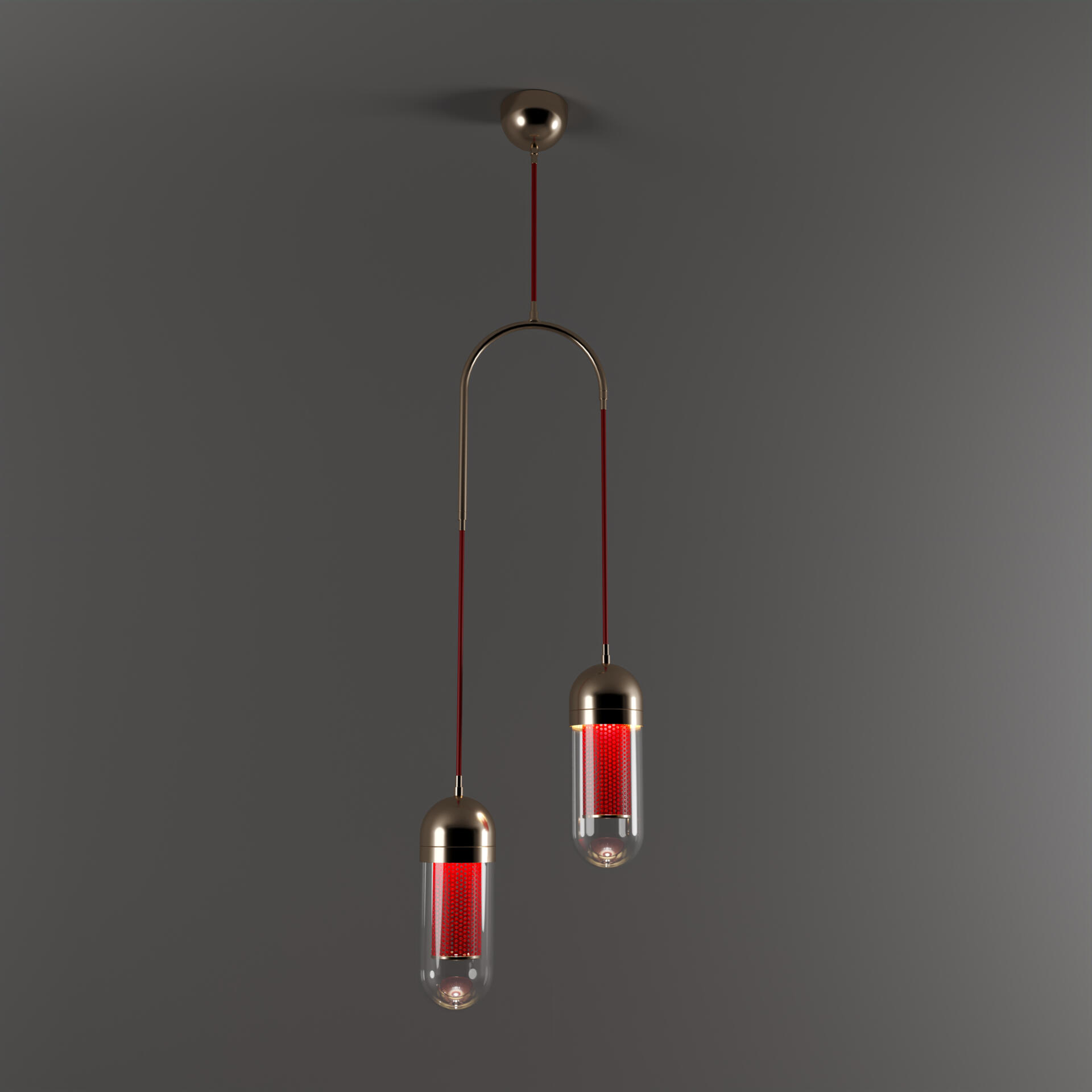 Dender II Pendant Lamp lacquered in red with polished brass details, light turned on and shining through the perforated metal.