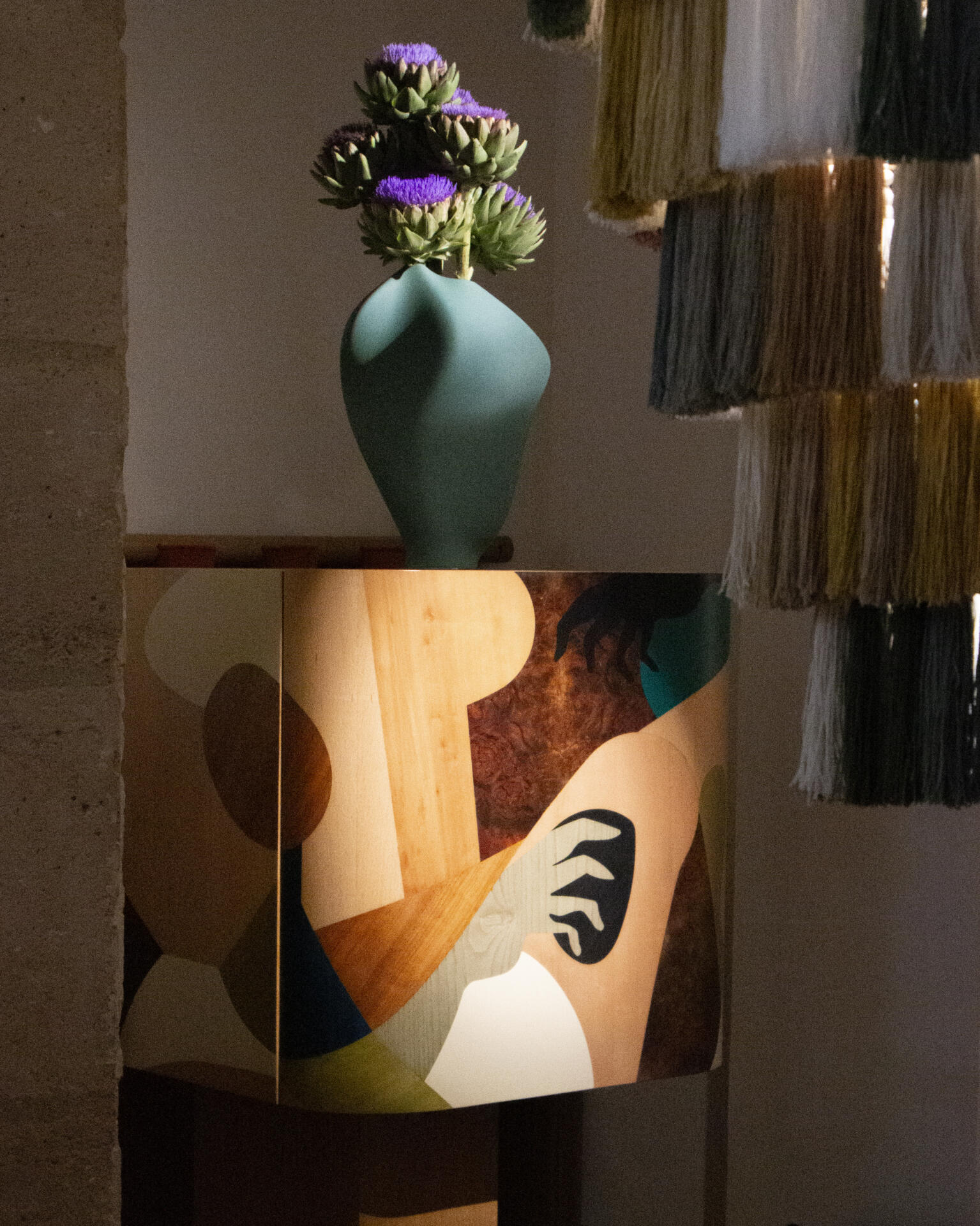 Close-up of the ih maj in cabinet with marquetry drawings under dramatic light.