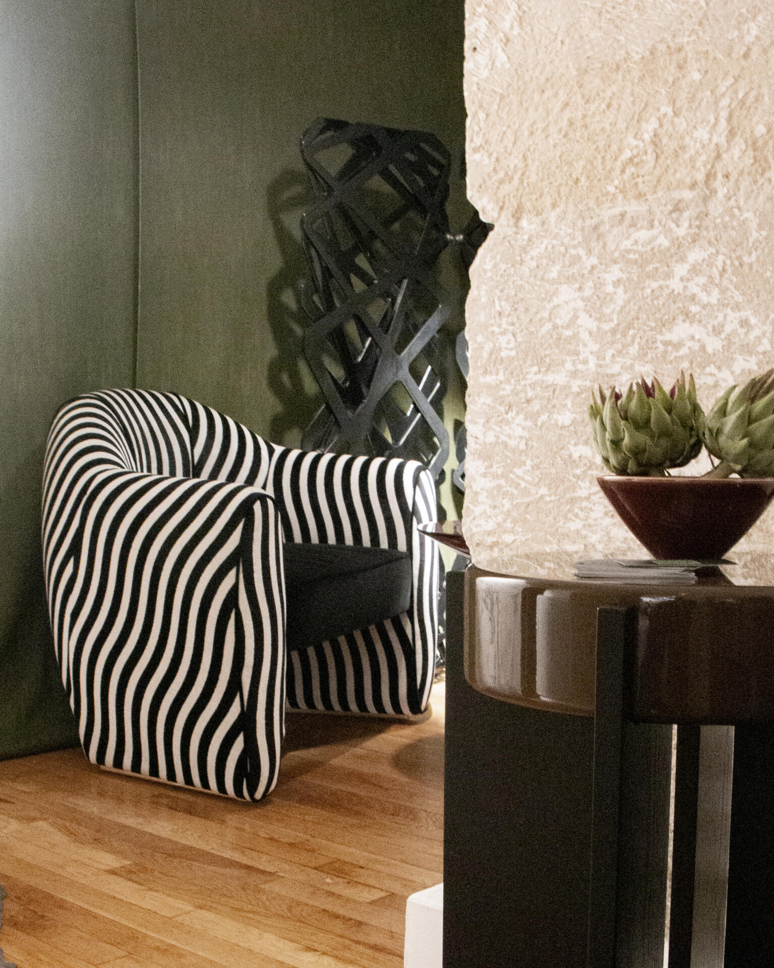 Viginti xx armchair at paris design week 2025, upholstered in wavy black and white striped fabric.