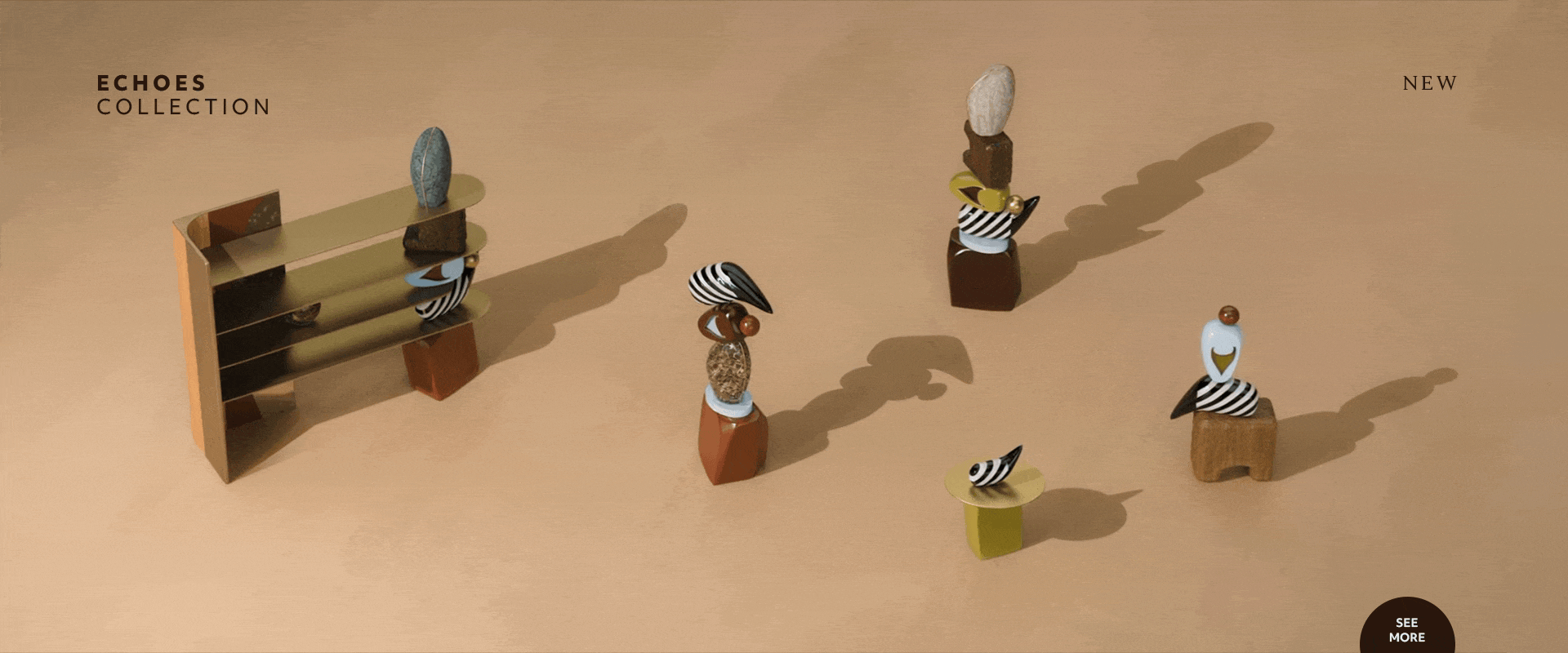 A horizontal animation of the echoes collection by malabar. The scene features a modular brass bookshelf with curved shelving, alongside handcrafted totems made of stacked wood, marble, and striped ceramic elements. A minimalist pedestal side table is also visible. The pieces are arranged on a warm sand-toned background with long, dramatic shadows that shift with the light. Text reads "echoes collection" and "new".