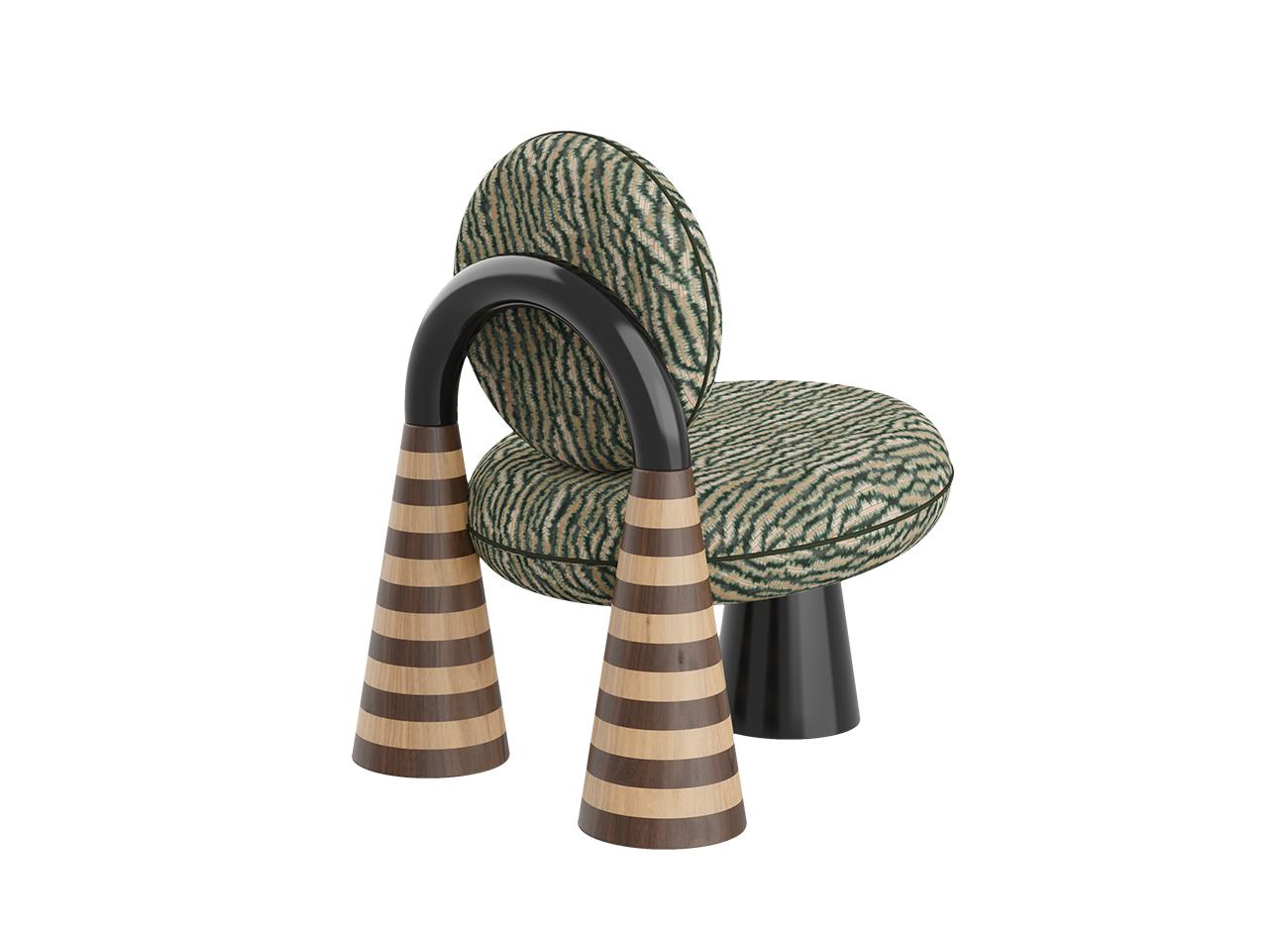 A rear-three-quarter view of the totara armchair by malabar. This version is upholstered in a textured green and beige misia fabric. The image highlights the fluid curve of the glossy black lacquer arch and the horizontal oak and smoked walnut marquetry stripes on the two rear conical legs, emphasizing the chair's architectural and geometric profile.