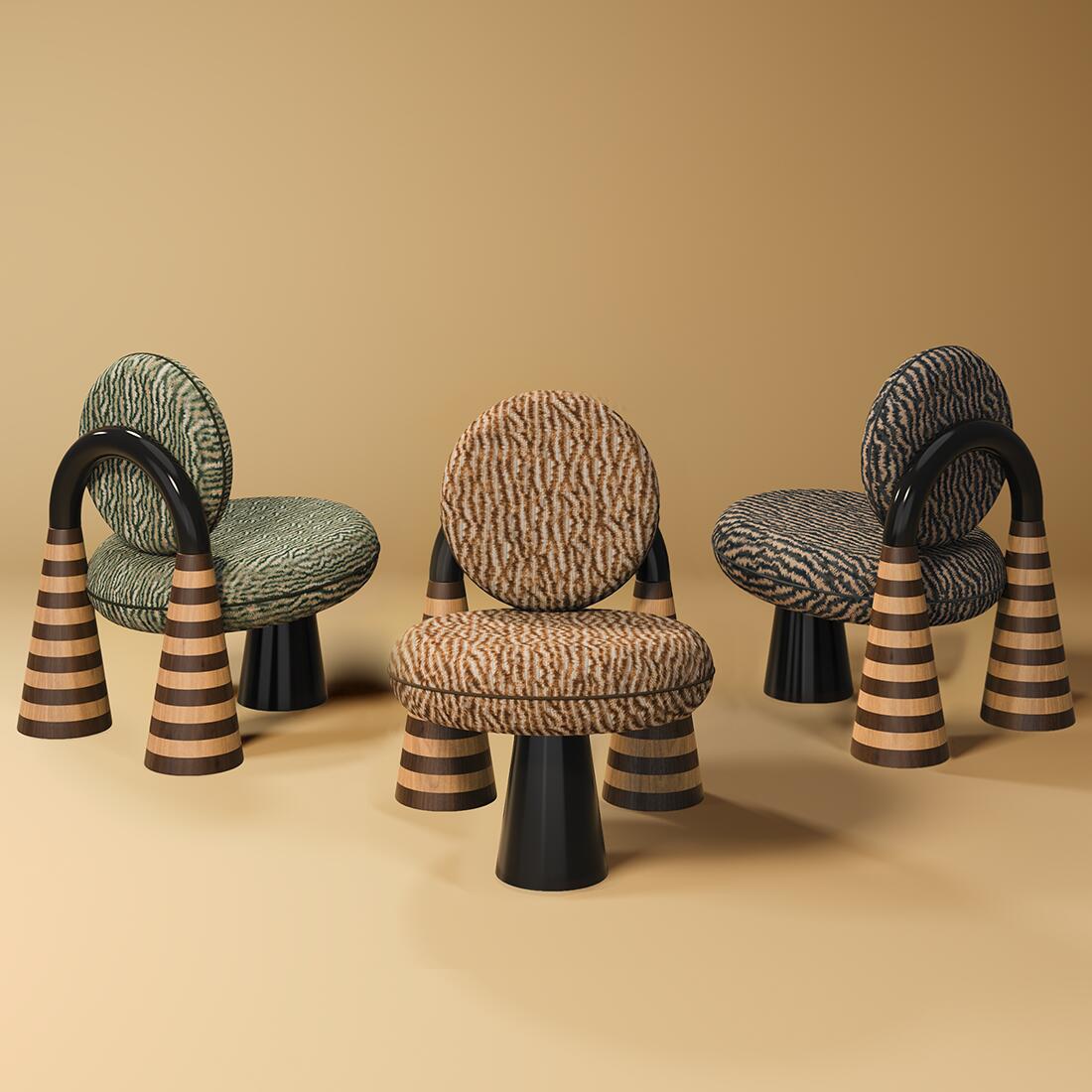 A studio composition featuring three Totara Armchairs by Malabar, showcasing a sculptural postmodern design. Each armchair has voluminous, circular seat and backrest cushions upholstered in Misia fabric with textured organic patterns in shades of green, earth, and grey. The back structure is defined by a dramatic arch in high-gloss black lacquer, resting on two chunky conical legs featuring handcrafted oak and smoked walnut checkerboard marquetry. A third central cone-shaped leg in black supports the front. The set is arranged against a neutral, warm-toned background, highlighting the statuesque silhouette of the pieces.