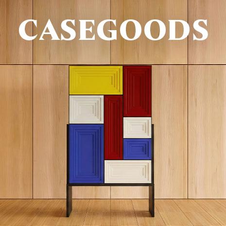 A modern cabinet, the venezia cabinet, with a colorful facade inspired by mondrian, featuring recessed rectangular panels in yellow, red, blue, and white. The word "casegoods" is displayed in bold white text over a light wood-paneled background.