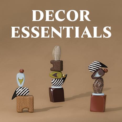 Three, echoes totem, set against a tan background. The words "decor essentials" appear in bold white text above them.