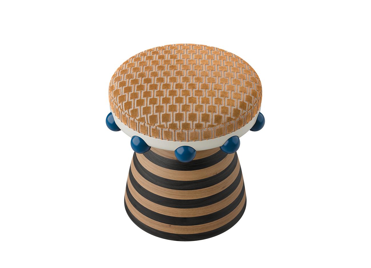 A high-angle view of the krom mea stool highlights the intricate rhythm of the orange velvet upholstery. The perspective showcases the circular form of the seat and the bold, striped wooden structure below.